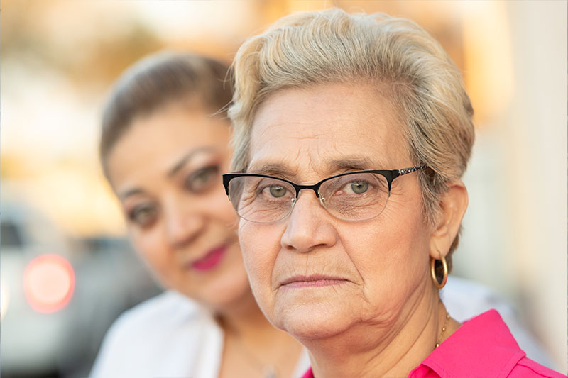An older woman is with her adult daughter who is facing several common family caregiver challenges. 